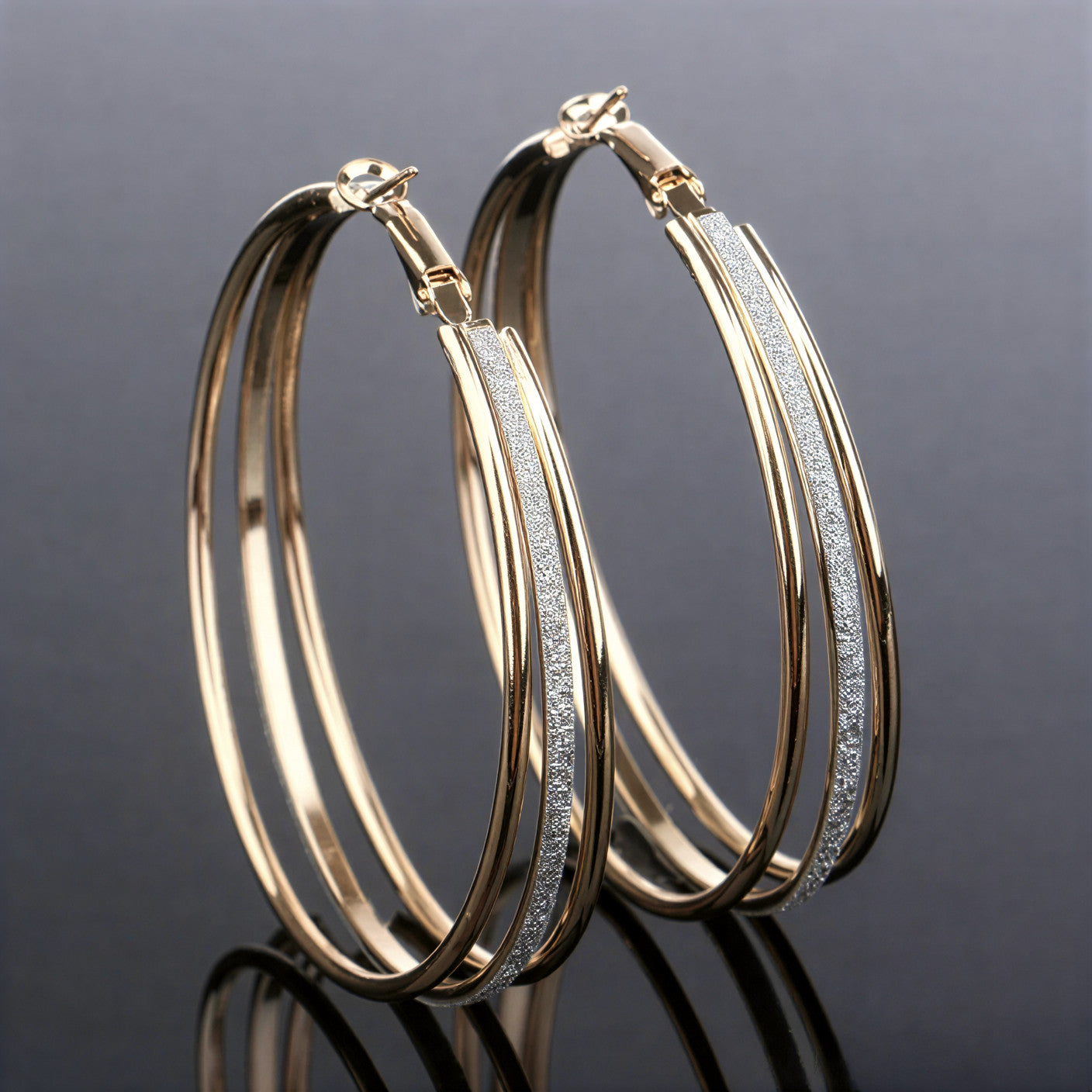 Gold hoop earrings with twisted detail and slim crystal pave strip, hinged back