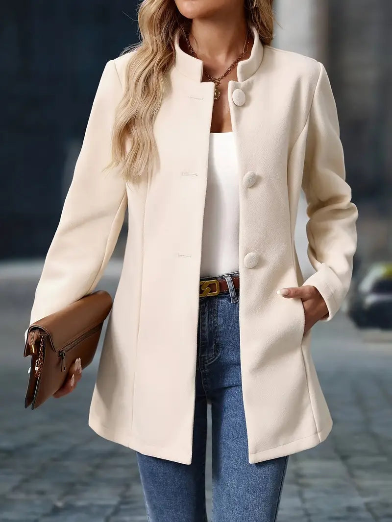 Cream button-up tailored coat with notch lapels, rounded buttons, and side pockets