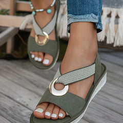 Green flat sandals with beaded ankle strap and round gold-tone metal buckle