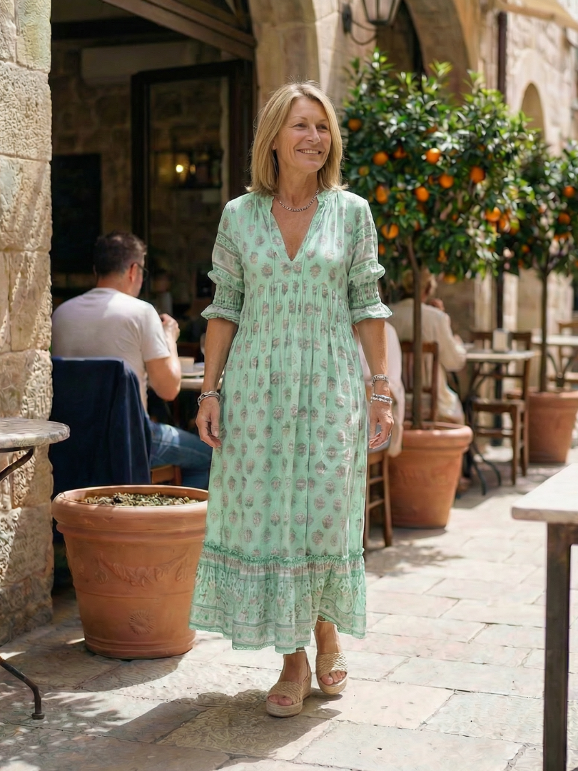 Sky blue V-neck tiered midi dress with short puff sleeves, small floral print
