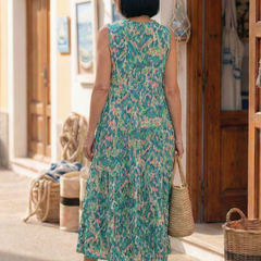 Back view of green sleeveless printed midi dress with tiered skirt