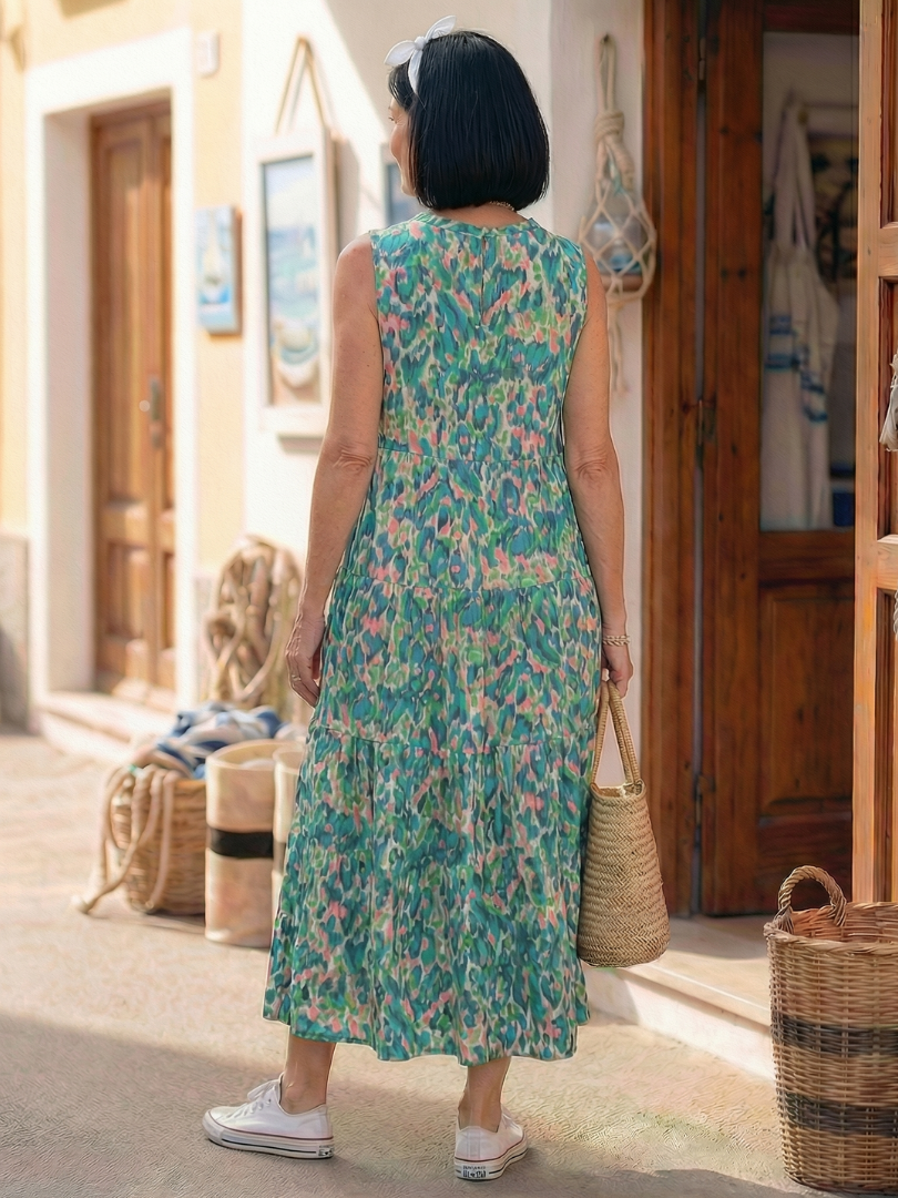 Back view of green sleeveless printed midi dress with tiered skirt