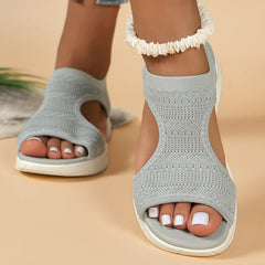 Grey knit slide sandals with open toe and ankle cuff, white cushioned sole