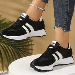 Black comfort sneakers with white side stripes and lace-up front, chunky sole