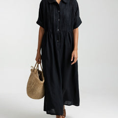 Black shirt dress with short sleeves, button front, and gathered waist, midi length