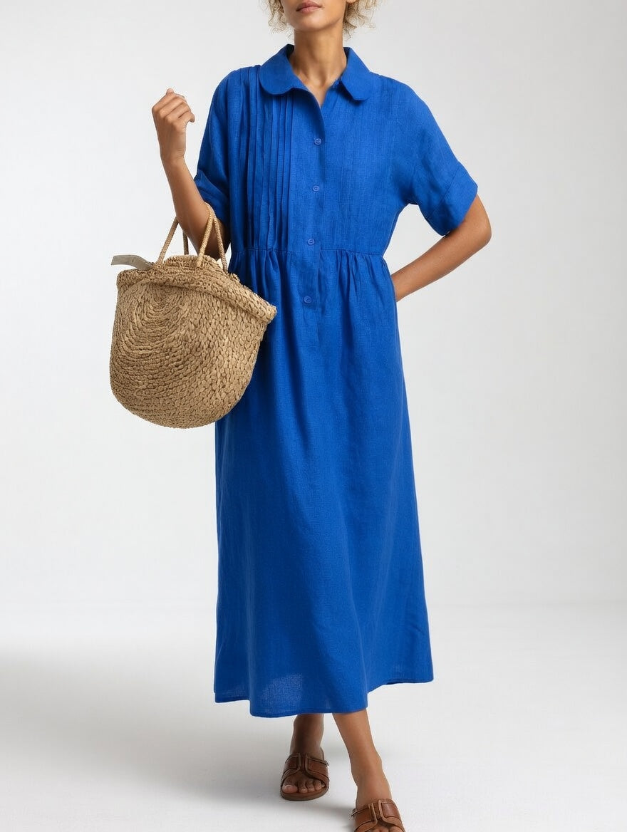 Blue shirt dress with short sleeves, button front, and gathered waist, midi length
