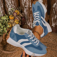 Light blue comfort sneakers with white side stripes and lace-up front, chunky sole
