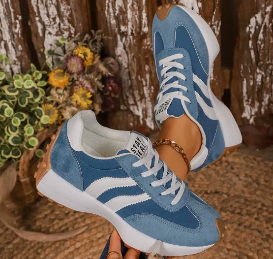 Light blue comfort sneakers with white side stripes and lace-up front, chunky sole