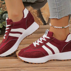Burgundy comfort sneakers with white side stripes and lace-up front, chunky sole