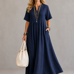Navy pleated maxi dress with V-neck and short sleeves, gathered waist.