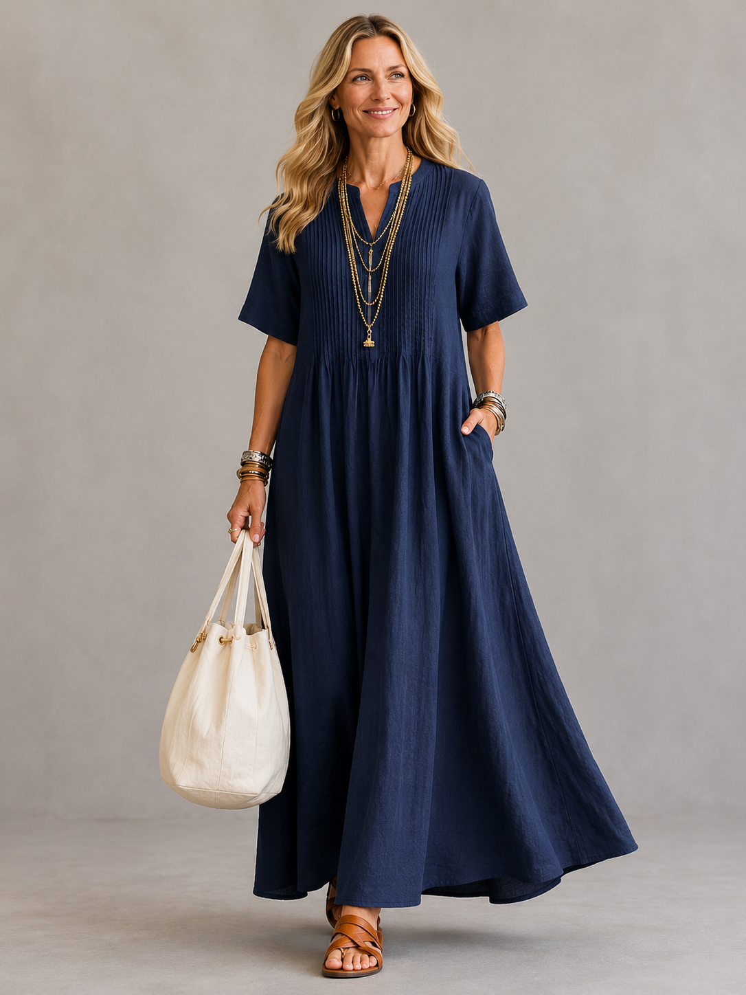 Navy pleated maxi dress with V-neck and short sleeves, gathered waist.