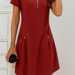Red zip-front midi dress with short sleeves and button accents at the pockets