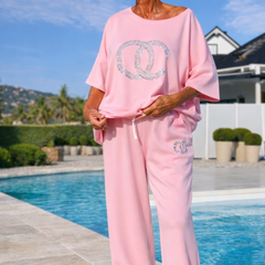 Pink two-piece lounge set with loose crew T-shirt and drawstring wide-leg pants