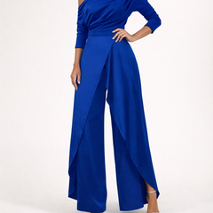 Blue one-shoulder overlay jumpsuit with long sleeves and flowing wide-leg pants.