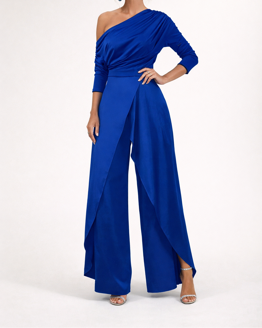 Blue one-shoulder overlay jumpsuit with long sleeves and flowing wide-leg pants.
