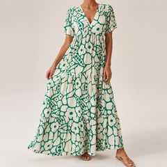 Green-and-white tiered midi bohemian dress with short sleeves and bold circular print