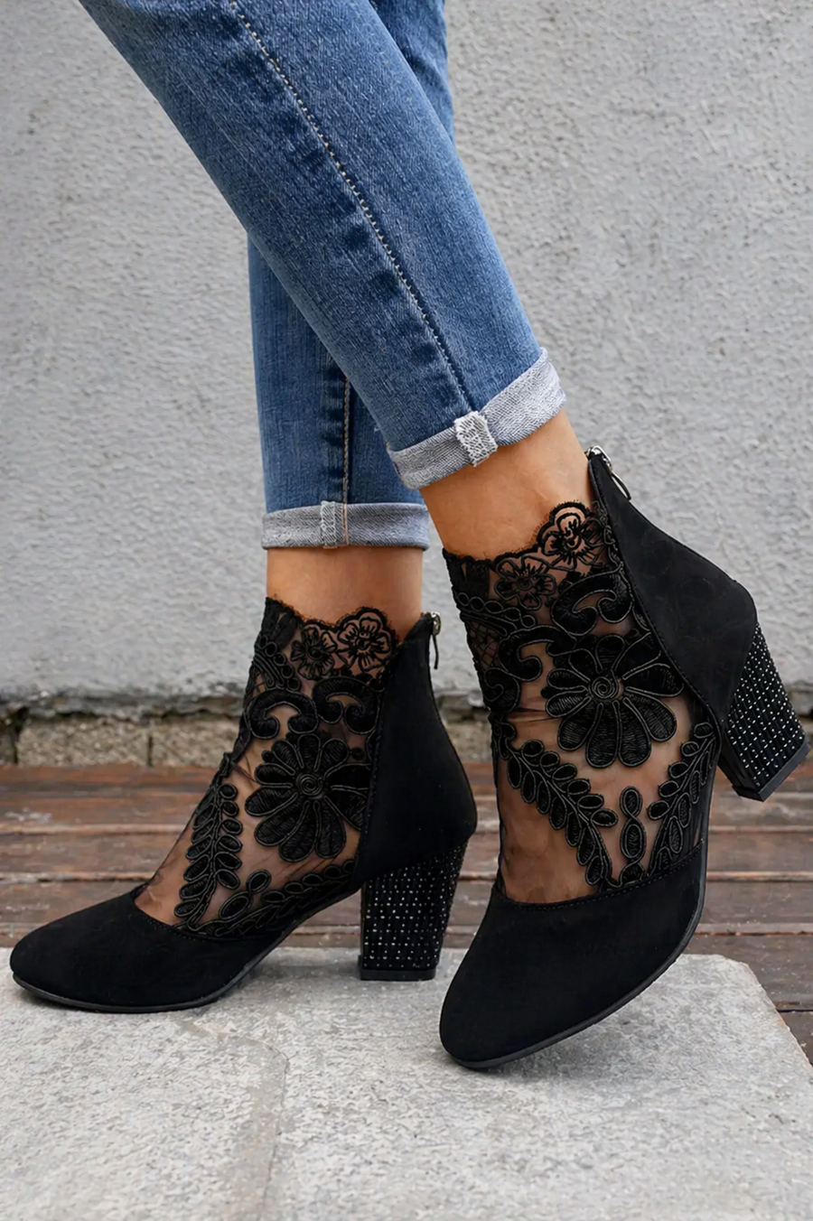 Black orthopedic heeled ankle boots with floral lace cutouts and block heel