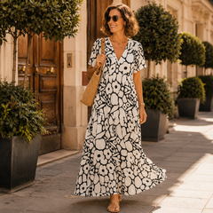 Black-and-white tiered maxi bohemian dress with short sleeves and bold circular print