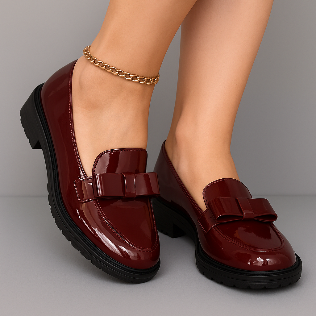 Red patent loafers with chunky block heel and buckle strap across the vamp