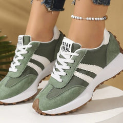 Olive green comfort sneakers with white side stripes and lace-up front, chunky sole