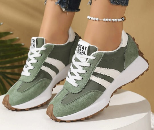 Olive green comfort sneakers with white side stripes and lace-up front, chunky sole