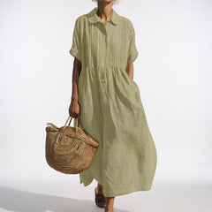 Light green shirt dress with short sleeves, button front, and gathered waist, midi length