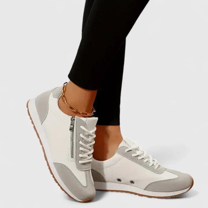 White and grey comfort sneakers with lace-up front, side zipper, and tan rubber sole