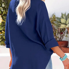 Marine blue loose-fitting button-up blouse with long sleeves, back view and side angle.