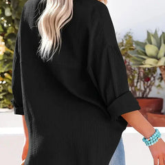 Black loose-fitting button-up blouse with long sleeves, back view and side angle.