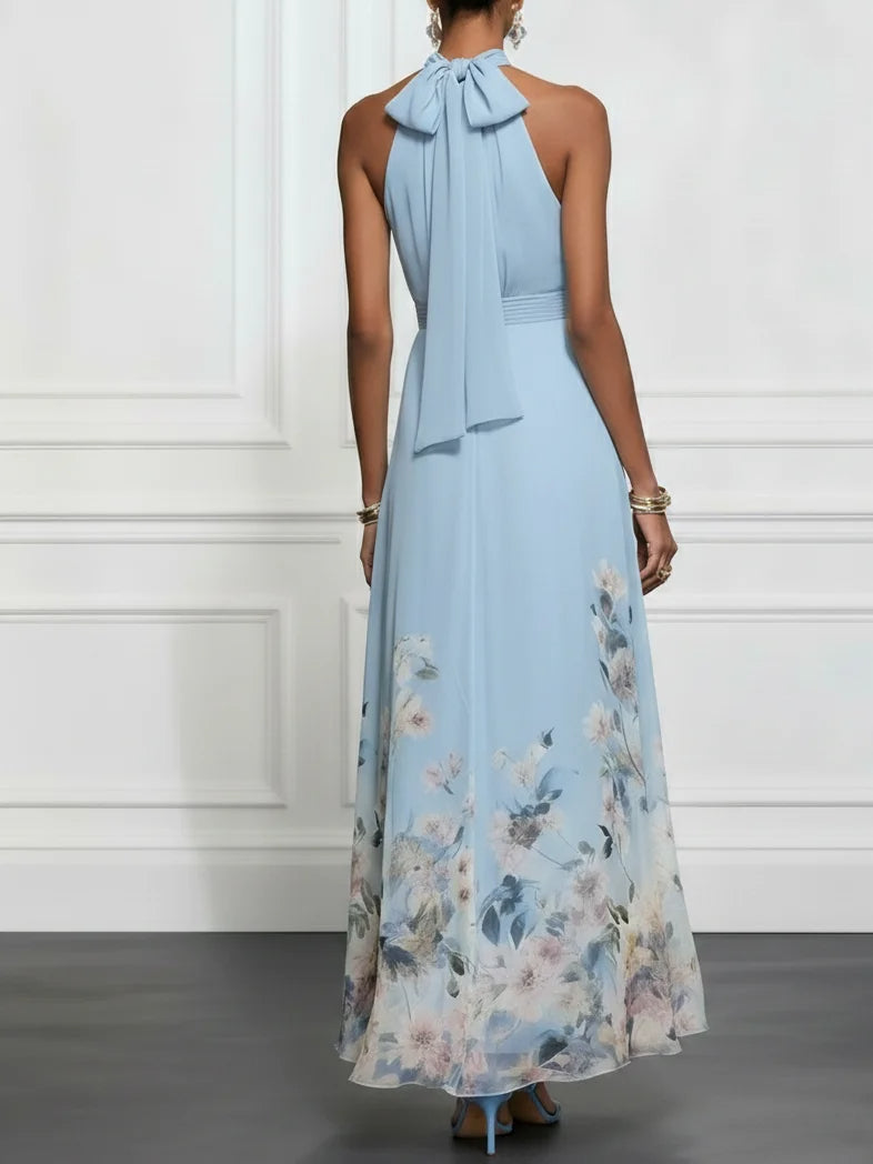 Light blue halter maxi dress with neck bow and floral print hem