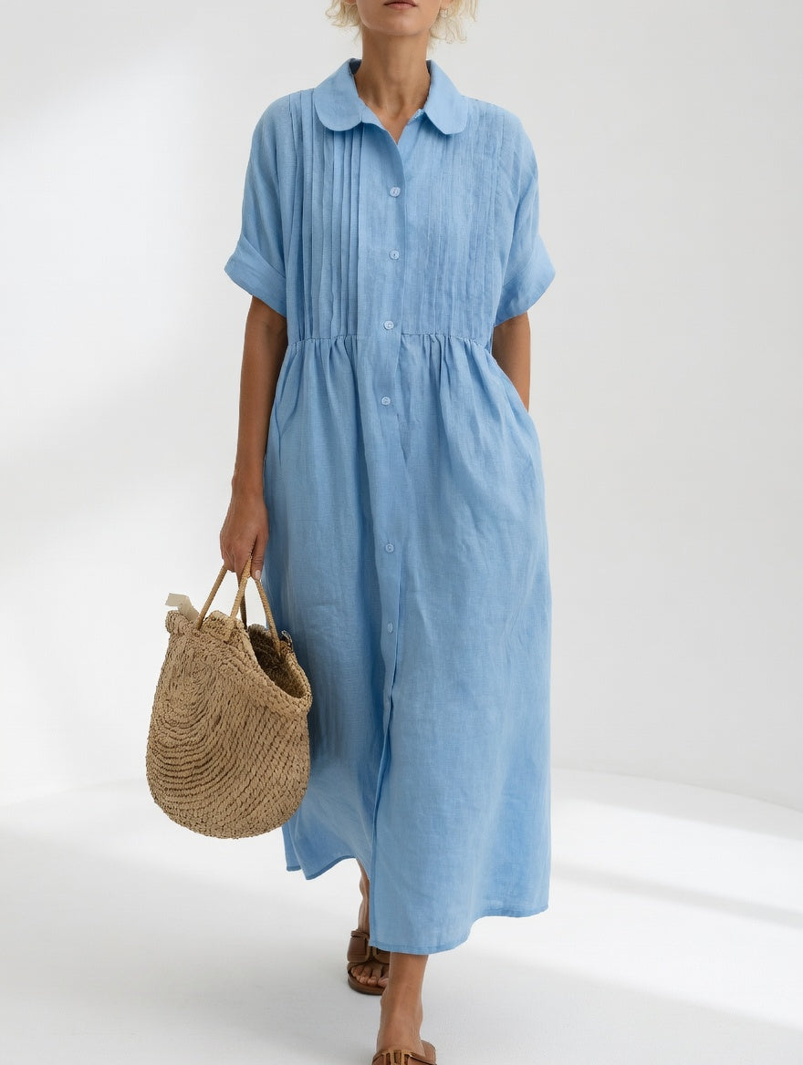 Light blue shirt dress with short sleeves, button front, and gathered waist, midi length