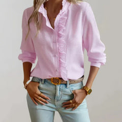 Light pink button-up ruffle blouse with high neckline and long sleeves, front view