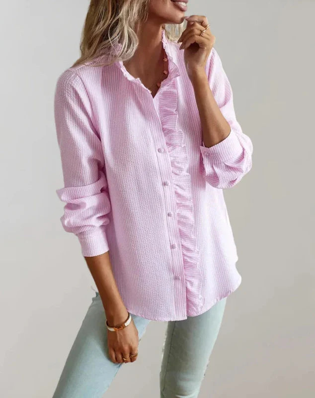 Light pink ruffle-front blouse with button placket and long sleeves, front view