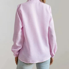 Light pink button-up blouse with long sleeves and collar, back view