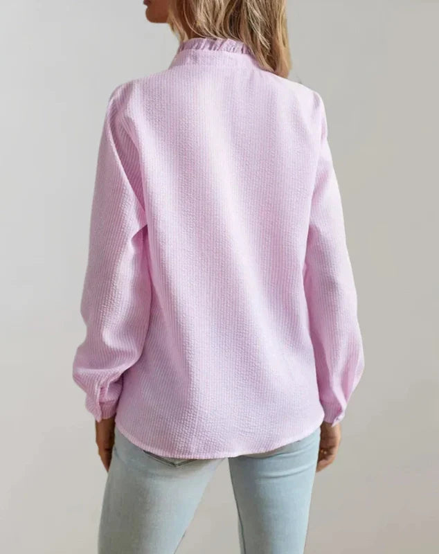 Light pink button-up blouse with long sleeves and collar, back view