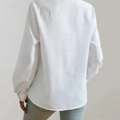 White button-up blouse with long sleeves and back yoke detail, back view