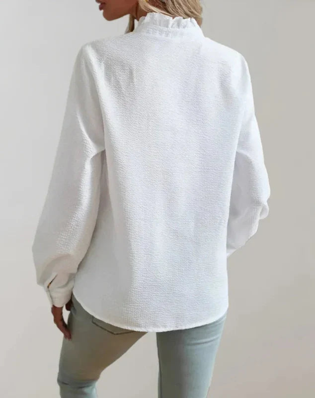 White button-up blouse with long sleeves and back yoke detail, back view