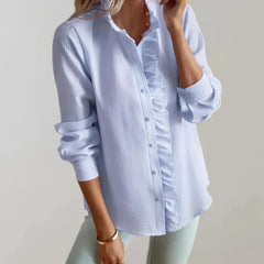 Light blue blouse with ruffle trim at front and buttoned placket, long sleeves