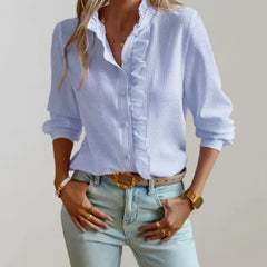 Light blue ruffle-front blouse with button placket and gathered neckline, long sleeves