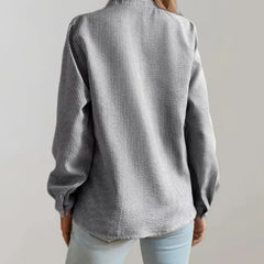 Grey ruffle-front blouse, long sleeves, button placket; back view