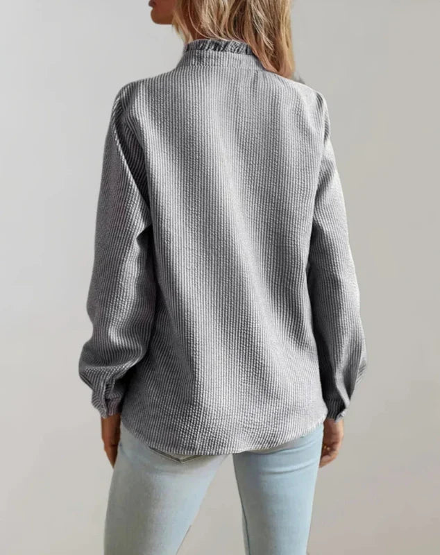 Grey ruffle-front blouse, long sleeves, button placket; back view