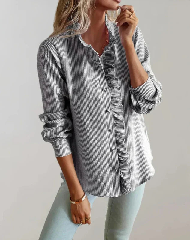 Grey ruffle-front button-up blouse with long sleeves and stand collar detail