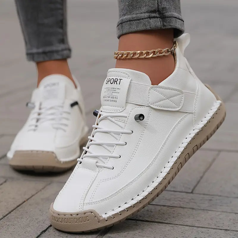 White comfort sneakers with lace-up front, side panel details, and chain ankle strap