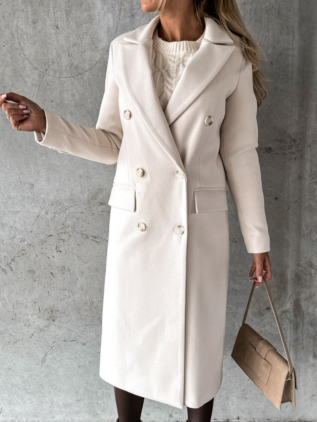 Cream long double-breasted coat with notched lapel, front button placket, flap pockets