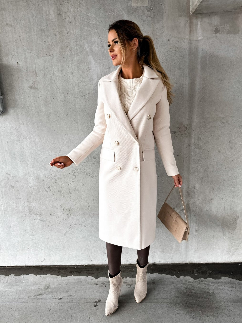 Cream long coat with notched lapel, double-breasted buttons, side flap pockets