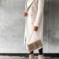 Cream long coat with notched lapel, double-breasted buttons, flap pockets, side view