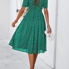 Green polka-dot midi dress with short sleeves and gathered waist, flared skirt