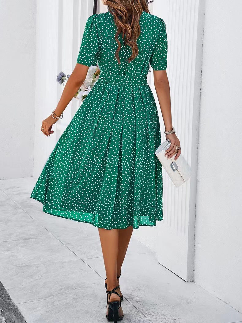 Green polka-dot midi dress with short sleeves and gathered waist, flared skirt