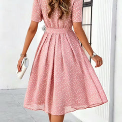 Pink polka-dot dress with short sleeves and tie waist, flared midi skirt (back view)
