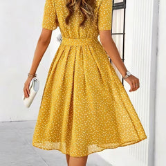 Yellow polka-dot dress with short sleeves and tie waist, flared midi skirt (back view)